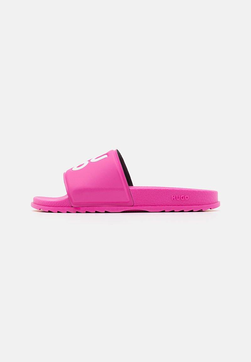 Bright pink slide sandal featuring a glossy finish, wide strap, and black inner lining. Textured sole with a subtle logo detail.