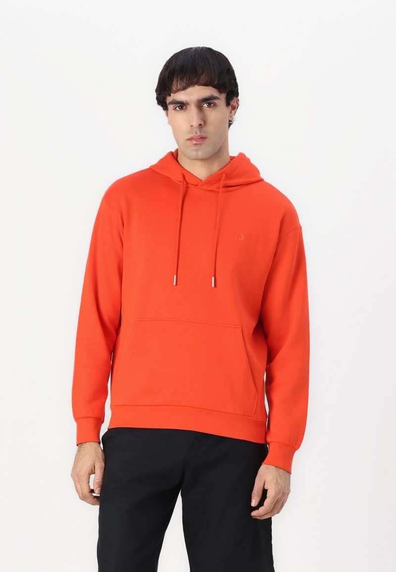 Orange hoodie with a front pocket, drawstring hood, and ribbed cuffs. Smooth texture, minimalist design with a small logo on the chest.
