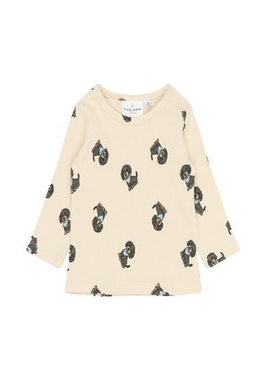 Cămașă pentru bebeluși, cu mânecă lungă, de culoare bej, cu ilustrații mici de câini negri purtând eșarfe albastre imprimate pe toată suprafața.