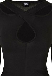 Schwarzes, tailliertes Oberteil mit einem überkreuzten Halsauschnitt und einem Schlüssellochdetail. Hergestellt aus glattem Stoff mit nahtlosem Design für ein schickes Erscheinungsbild.