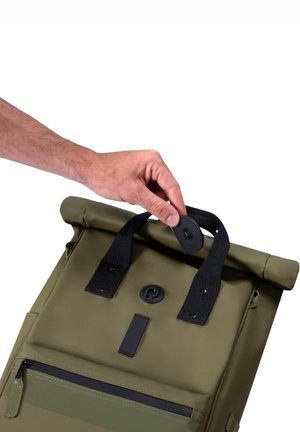 Olive green roll-top backpack with black accents, a rubberized handle, and a front zippered pocket. Textured material, adjustable straps.