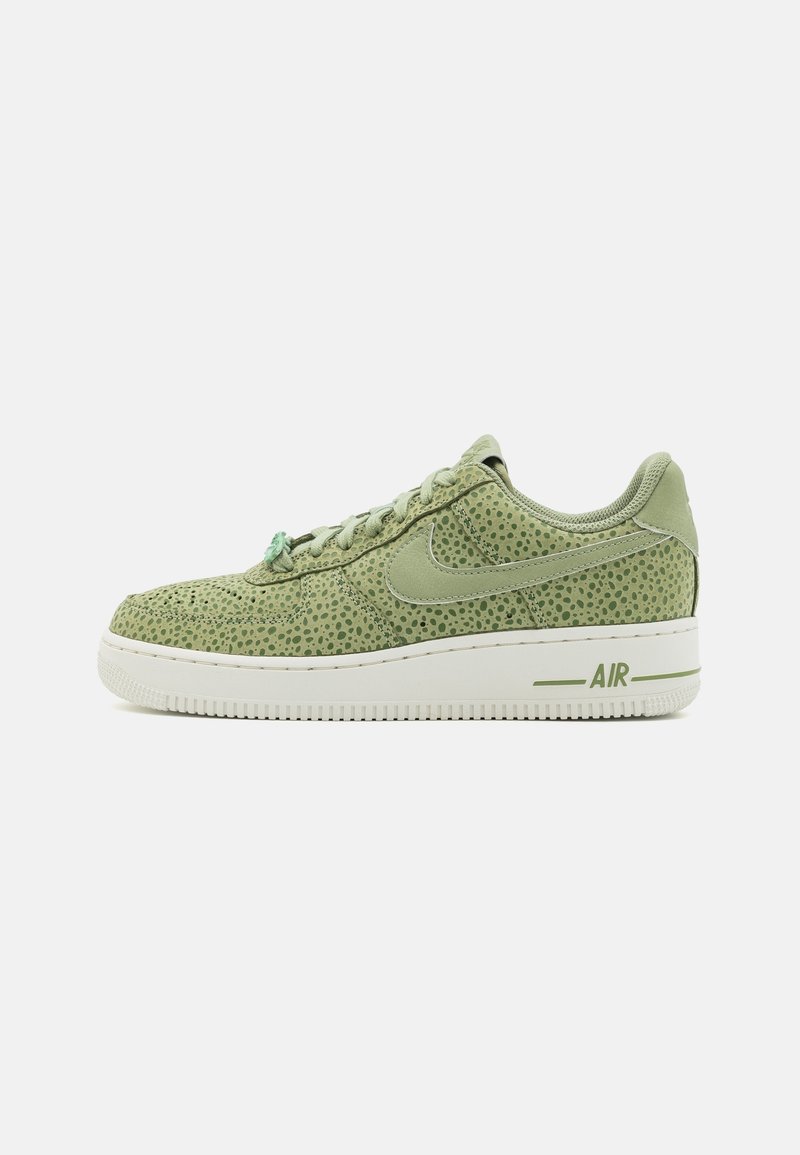 Baskets basses Nike Air vert olive avec motif à pois, lacets assortis et semelle blanche avec marquage "AIR" sur le côté.