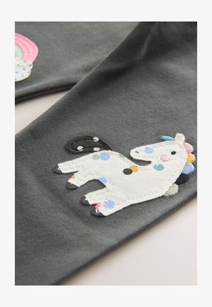 Grå bomuldsleggings med en hvid broderet enhjørning med farverige polkaprikker, detaljeret man og hale på venstre ben.