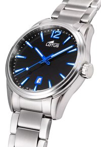 Reloj de acero inoxidable plateado con una esfera negra, marcadores de hora azules y indicador de fecha. Presenta manecillas luminosas y un acabado pulido.