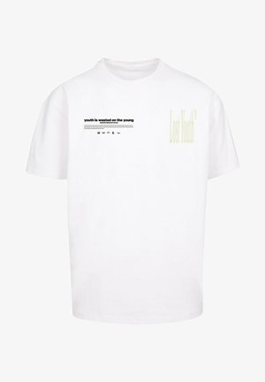 Fehér pamut póló rövid ujjakkal. Az elején fekete szöveg található: "a fiatalság a fiatalokra pazarolt" és egy világos zöld "Elveszett Fiatalság" grafika.