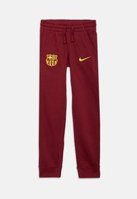 Calças de treino burgundy da Nike com cintura elástica, bolsos laterais, logotipo amarelo do Barça e swoosh amarelo da Nike. Teido macio em mistura de algodão.