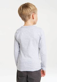 Gray long-sleeve shirt made of soft fabric, featuring a simple crew neckline. The texture appears smooth and lightweight.