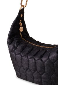 Black quilted bag with hexagonal pattern, gold zipper, and hardware. Features a curved shape and padded texture.