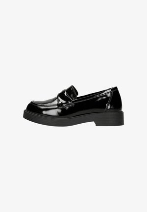 Black patent leather loafer with a low, textured sole. Features a rounded toe and a panel detail across the front.