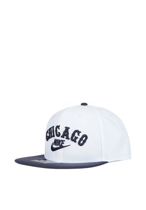 Cappellino da baseball Nike bianco e nero con la scritta "Chicago" ricamata in nero sul davanti e con visiera piatta nera.
