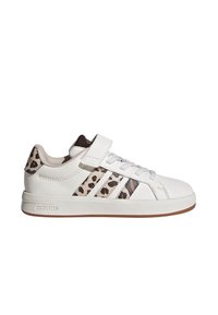White sneaker with leopard print stripes and accent. Features a Velcro strap and lace closure, topped with a rubber sole.
