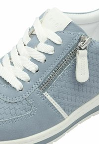 Light blue leather sneaker with woven texture, white laces, silver zipper detail, and white accents. Rubber sole for grip and comfort.