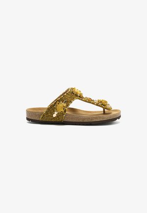Sandale tongs jaune perlée avec semelle en liège et grappes décoratives de pierres précieuses sur les brides, vue de côté sur fond blanc.