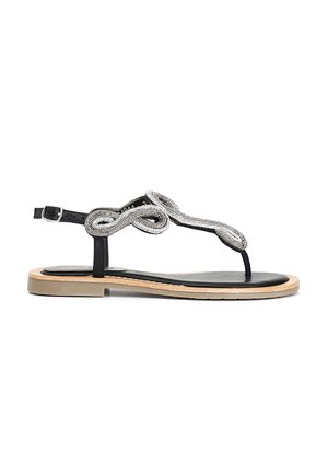 Sorte flade sandaler med et elegant design, med en perlekæde i sølv i et snoet mønster og en let træ sål. Justerbar ankelrem.