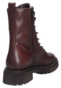 Brown leather ankle boot with a lace-up front, side zipper, and thick rubber sole. Smooth texture and a sturdy, rounded design.