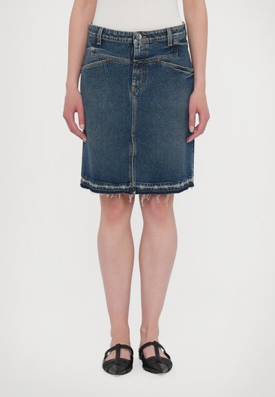 Donkerblauwe denimrok met rafelige zoom, voorzien van twee zijzakken en een ritssluiting. Rechte pasvorm en knielange ontwerp.