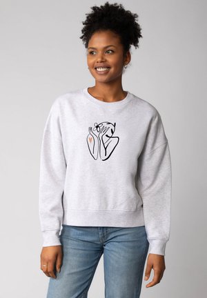 Hellgrauer Sweatshirt mit lässigem Schnitt, das auf der Vorderseite eine schwarze Strichzeichnung von Händen und einem Herzen zeigt. Weicher Stoff.