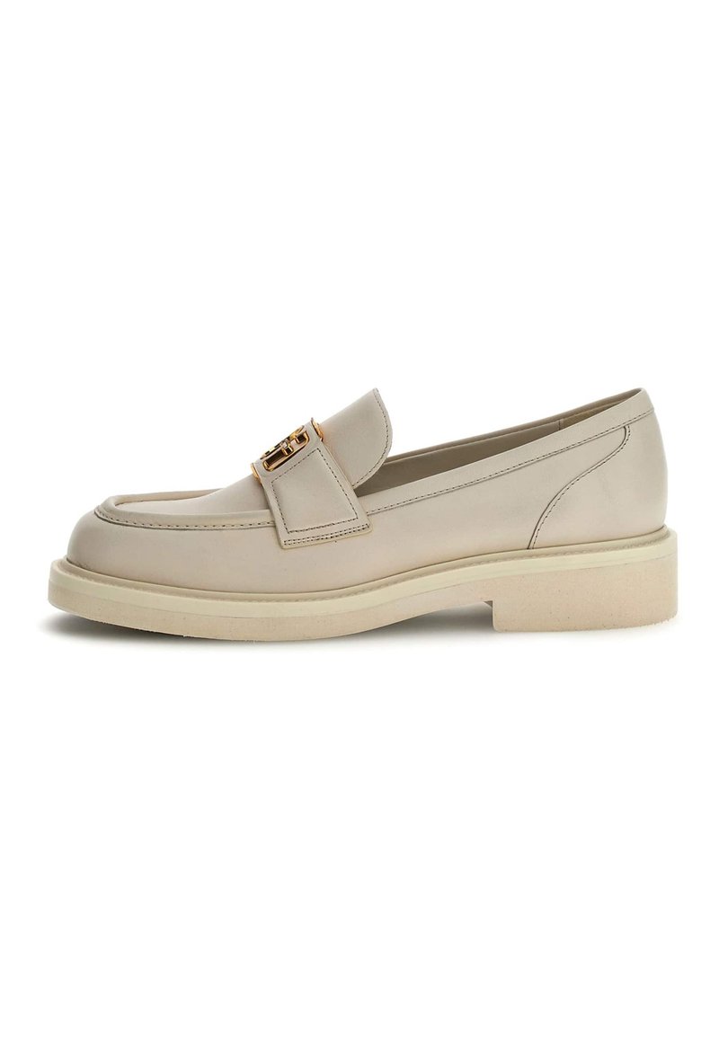 Beige leather loafer with a rounded toe, featuring a decorative gold-tone buckle and a light rubber sole with a textured finish.