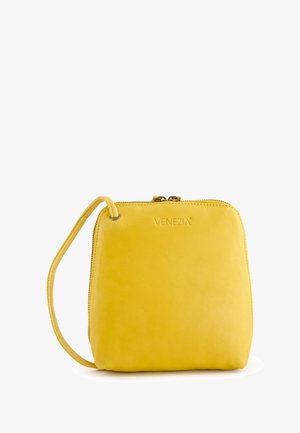Yellow leather handbag with a smooth finish, rectangular shape, top zip closure, and a detachable wrist strap. "VENEZIA" embossed.