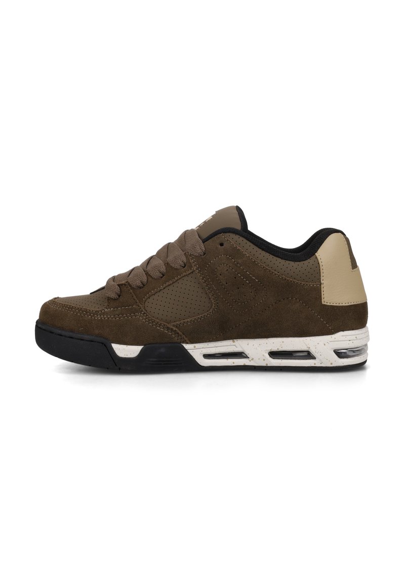 Brown suede sneaker with a perforated design, black sole, white speckled midsole, and tan leather accents on the heel and tongue.