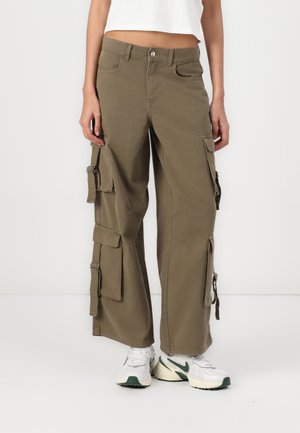 Olive green cargo pants with a wide-leg design, multiple side pockets, silver hardware accents, and a sturdy cotton material.