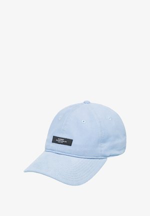 Light blue corduroy cap with a curved brim, featuring white eyelets and a black label with white text on the front.