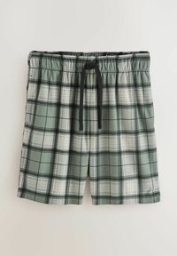 Grüne kariierte Shorts zeichnen sich durch einen schwarzen Kordelzug, einen elastischen Bund und eine Mischung aus hellen und dunklen Karomustern auf einem glatten Stoff aus.