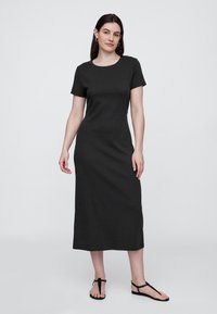 Črna bombažna obleka s kratkimi rokavi, okrogel izrez, dolžina do polovice meč, z ravnim krojem in gladko teksturo.