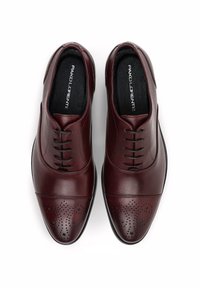 Burgundowe skórzane buty do garnituru o gładkim wykończeniu, z perforowanym designem toe, sześcioma otworami do sznurowania oraz solidną czarną gumową podeszwą.