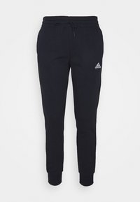 Pantalones de chándal negros de algodón con piernas ajustadas, cintura elástica y cordón ajustable. Presenta un pequeño logo blanco de Adidas en el muslo izquierdo.