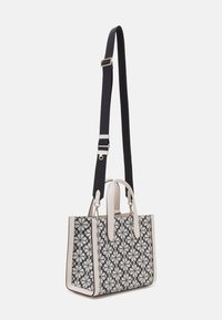 Borsa a mano con motivo floreale in bianco e nero, dettagli in crema a contrasto, forma strutturata, doppio manico e tracolla staccabile di colore scuro.
