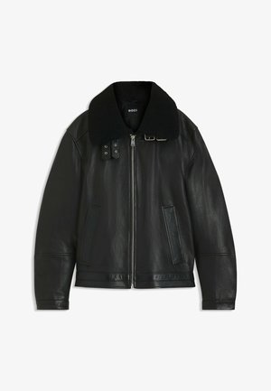 Black leather jacket with a wide, black shearling collar, front zip closure, and two side pockets. Features metallic hardware accents.