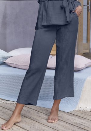 Top grigio, morbido e dalla vestibilità ampia con pantaloni a gamba larga e vita con cravatta. Il tessuto presenta una finitura stropicciata. Materiale morbido e traspirante.