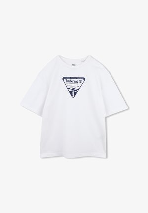T-shirt en coton blanc avec un graphique triangulaire bleu marine représentant des arbres et de l'eau, portant l'inscription "Timberland Coastal Tours". Manches courtes et ample.