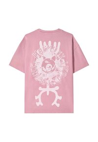 Pink cotton t-shirt featuring large white printed graphic on the back, including text and circular design elements with abstract patterns.