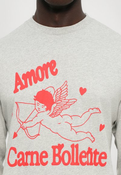 Gray sweatshirt featuring red graphic text "Amore" and "Carne Bollente" with an illustration of a cherub holding a bow and arrow and red hearts.