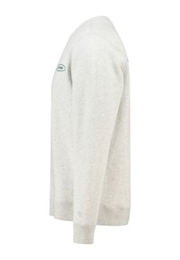 Harmaa huppari, joka on valmistettu pehmeästä kankaasta. Siinä on ribattu pyöreä kaula-aukko, pitkät hihat ja pieni brodeerattu logo rinnassa.