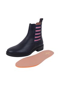 Czarne skórzane botki za kostkę z paskami elastycznymi w paski po bokach i pętelką z tyłu; zawierają wyjmowaną beżową wkładkę z pomarańczowymi akcentami.