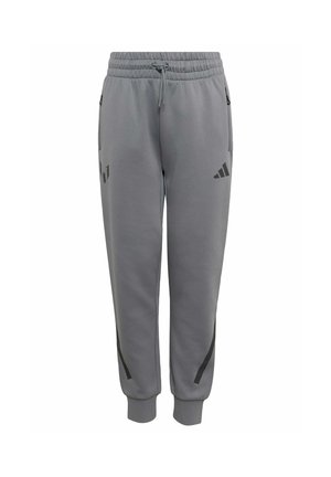 Grå atletiske joggingbukser med elastisk linning, snor, lynlåslommer i siderne og sorte Adidas- og Messi-logoer på forbenene.