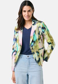 Colorful blazer with an abstract pattern in green, blue, pink, and yellow. Features a single button, notched lapels, and a fitted design.