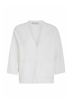 Valge kardigan pehmest kudumisest, millel on V-kujuline kaelus, kolmveerandi pikkused varrukad, ees nupuga sulgemine ja kaks ees olevat klapikotti.