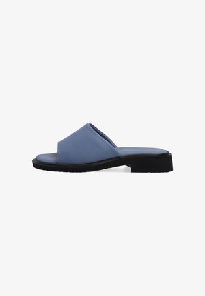 Blue leather slide sandal with a smooth finish, open-toed design, and a black rubber sole. Features a contemporary crossed upper strap.