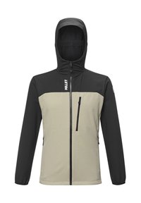Veste à capuche avec manches noires et haut de la poitrine, torse beige, fermeture éclair à l'avant, poche poitrine zippée et logo "MILLET" sur la poitrine et la manche.