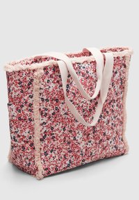 Torebka płócienna z nadrukiem kwiatowym w kolorze czerwonym, różowym i granatowym, z jasnoróżowym frędzlem oraz dopasowanymi jasnoróżowymi paskami na ramię.