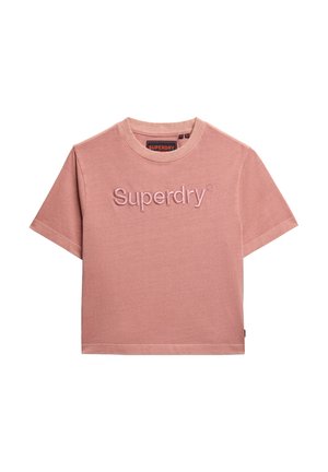 T-shirt in cotone rosa con girocollo e maniche corte, caratterizzata dal testo in rilievo "Superdry" al centro. Texture liscia, vestibilità casual.