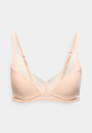 Soutien-gorge sans fil rose clair avec panneau en mesh transparent, bretelles fines réglables et bonnets moulés doux sur fond blanc.