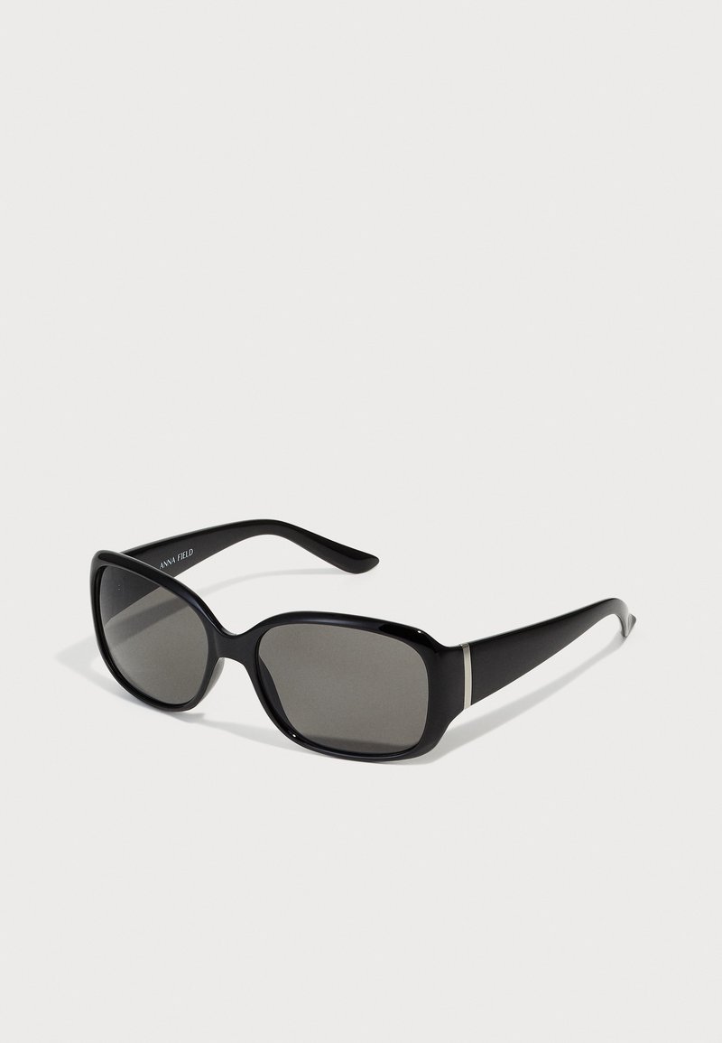 Black rectangular sunglasses with dark lenses, a smooth plastic frame, and silver accent on the temples.