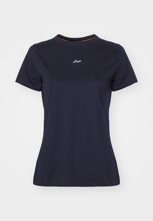 Granatowa bawełniana koszulka z okrągłym dekoltem, krótkimi rękawami i małym białym haftowanym logo na piersi. Gładka faktura.