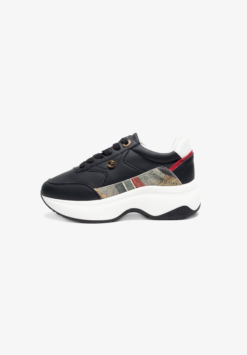 Black synthetic sneaker with a textured fabric panel featuring beige, green, and red stripes. Thick white sole and black accent details.