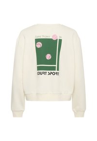 Sweatshirt crème avec un design graphique comprenant des motifs de tennis verts et roses, le texte "Court Sport" et le détail "Saint Tropez '86".